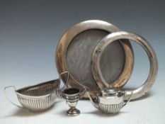 A HALLMARKED SILVER CIRCULAR PICTURE FRAME, together with a smaller hallmarked silver picture