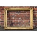 A 19TH CENTURY DECORATIVE GOLD FRAME WITH CORNER EMBELLISHMENTS AND GOLD SLIP, frame W 10 cm, slip