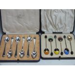 A CASED SET OF SIX ART DECO COFFEE BEAN SPOONS WITH ENAMEL DECORATION, unmarked gilt metal, together