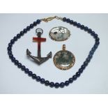 A SINGLE STRAND LAPIS LAZULI POLISHED BEAD NECKLACE, together with a moss agate circular pendant, an