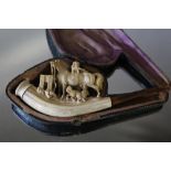 A CARVED MEERSCHAUM PIPE, carved with dogs playing around a horse, W 14.5 cm