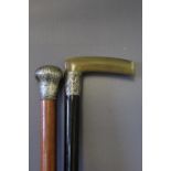 TWO WALKING CANES, one silver topped malaca and the other a silver banded horn handled example, A/F,