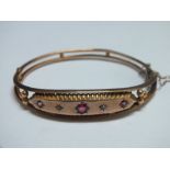 A HALLMARKED 9 CT GOLD GEM SET BANGLE, approx weight 7.1g, W 6 cm