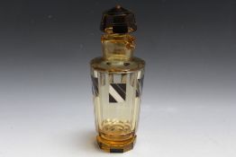 AN ART DECO GLASS DECANTER WITH ENAMEL DECORATION, pale amber coloured faceted body with black and