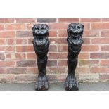 A PAIR OF 18TH CENTURY CARVED LION NEWEL POSTS, outward facing with jaws open, rears and tops