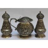 A GOOD QUALITY INDIAN SILVER THREE PIECE CRUET SET BY OOMERSI MAWJI, court silversmith to The