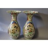 A PAIR OF ORIENTAL BALUSTER VASES WITH FRILLED RIMS, each vase decorated with a figure in a shaped