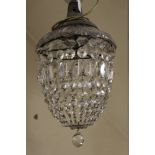 A GLASS CRYSTAL LUSTRE CEILING LIGHT WITH MOUNTING ROSE. having various cut glass droppers forming a