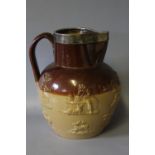 A VICTORIAN SALT GLAZE STONEWARE JUG WITH HALLMARKED SILVER RIM, the jug decorated in relief with