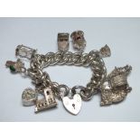 A HALLMARKED SILVER HEAVY LINK CHARM BRACELET WITH CHARMS, the links individually stamped with