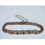 AN ANTIQUE YELLOW METAL CHAIN LINK BRACELET, the larger central links set with six turquoise