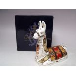 A ROYAL CROWN DERBY COLLECTORS GUILD LLAMA PAPERWEIGHT, gold stopper, with box, H 13 cm, L 14 cm