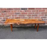 A MID 20TH CENTURY YEW WOOD COFFEE TABLE BY REYNOLDS OF LUDLOW, the shaped top raised on four
