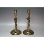 A PAIR OF ORIENTAL BRASS CANDLESTICKS, each with pierced raised bases, leading to stylised columns