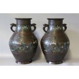 A PAIR OF ORIENTAL BRONZED BALUSTER SHAPED VASES, small areas of enamel decoration, character