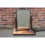 A 19TH CENTURY MAHOGANY DRESSING SWING MIRROR, the shaped rectangular glass banded in copper,