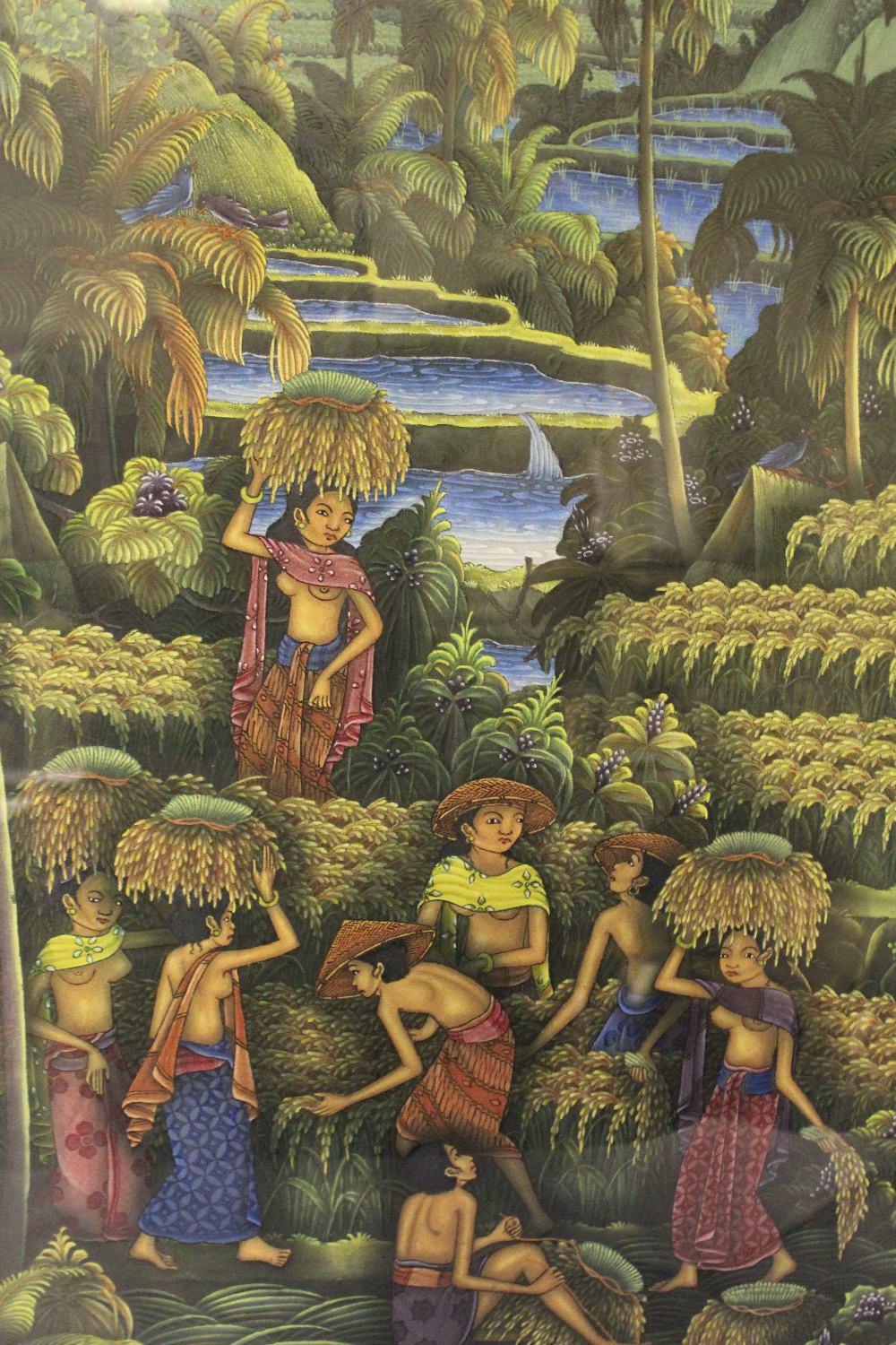A 20TH CENTURY BALINESE PAINTING OF A VILLAGE SCENE, mixed media and textile, signed lower right,