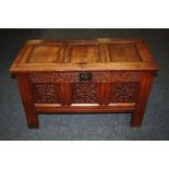 A LATE 18TH/EARLY 19TH CENTURY CARVED OAK COFFER OF SMALL PROPORTIONS, the hinged lid with