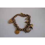 A 9ct GOLD AND YELLOW METAL CHARM BRACELET, charms include an 1853 USA $1