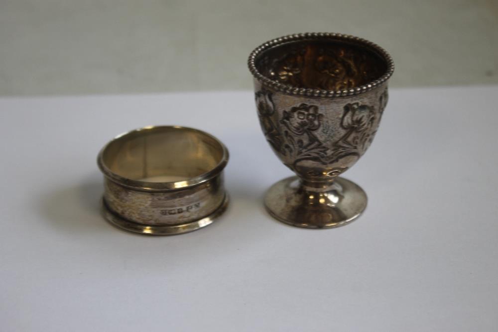 A HALLMARKED SILVER NAPKIN RING and egg cup (2)