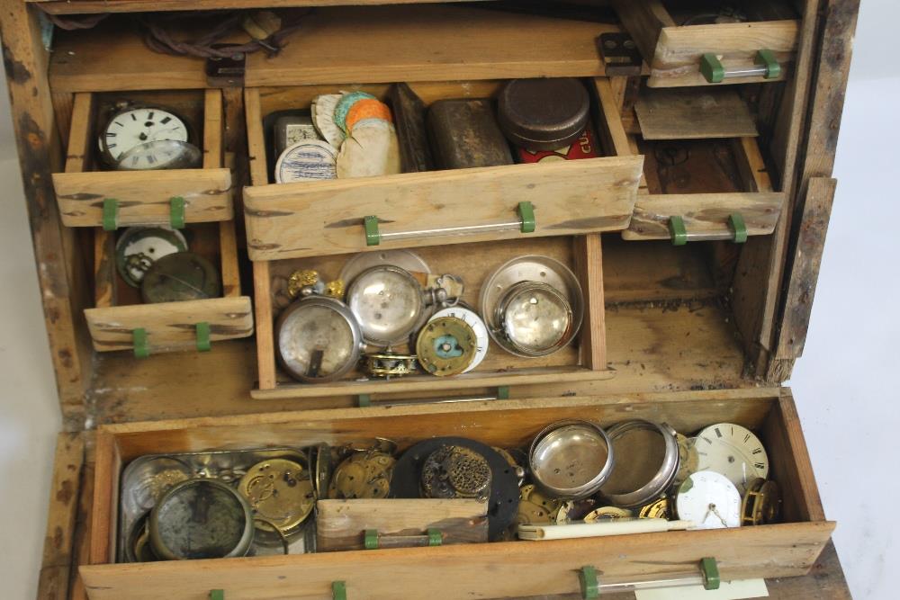 A CABINET OF POCKET WATCH PARTS, to include a selection of verge parts, movements, pair cases