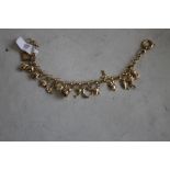 ROYAL MINT 9ct GOLD CHARM BRACELET, with special Royal Mint Tower charm in case of issue with COA.