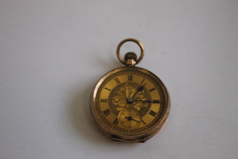 A 9ct GOLD LADIES' FOB WATCH, with gilt foliate dial, with black Roman Numeral markings.