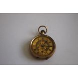 A 9ct GOLD LADIES' FOB WATCH, with gilt foliate dial, with black Roman Numeral markings.