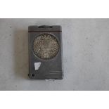 A VINTAGE LIFT ARM LIGHTER, inset with two Austrian Restrike Thaller Coins