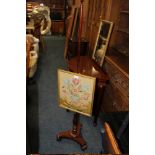 AN ANTIQUE MAHOGANY POLE SCREEN WITH LATER TAPESTRY SCREEN