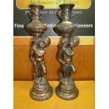 A PAIR OF LARGE COPPER EFFECT FIGURATIVE CANDLESTICKS