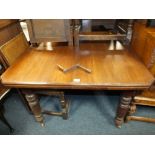 AN EDWARDIAN MAHOGANY WIND OUT DINING TABLE WITH ONE LEAF AND HANDLE