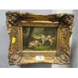 A SMALL GILT FRAMED OIL ON CANVAS DEPICTING DOGS RESTING IN A NATURAL SETTING