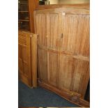 AN OAK LINENFOLD DOUBLE WARDROBE TOGETHER WITH BEDHEADS