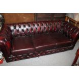 AN OXBLOOD RED LEATHER CHESTERFIELD