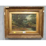 A GILT FRAMED ANTIQUE OIL ON CANVAS DEPICTING A WOODLAND BROOK SCENE,SIGNED LOWER RIGHT