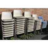 A LARGE QUANTITY OF STACKING CHAIRS WITH PADDED SEATS