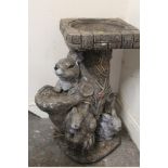 A TREE TRUNK DESIGN BIRDBATH WITH RABBIT FIGURES