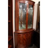 A REPRODUCTION MAHOGANY DOUBLE CORNER CABINET