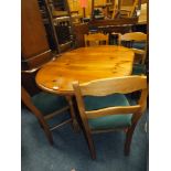 A HONEY PINE DROPLEAF TABLE AND FOUR CHAIRS