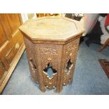 AN OCTAGONAL HEAVILY CARVED EASTERN SIDE TABLE