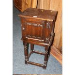 A SMALL OAK LINENFOLD BEDSIDE CABINET