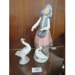 A LLADRO FIGURE OF A LADY FEEDING A DUCK, TOGETHER WITH A LLADRO DUCK FIGURE (2)