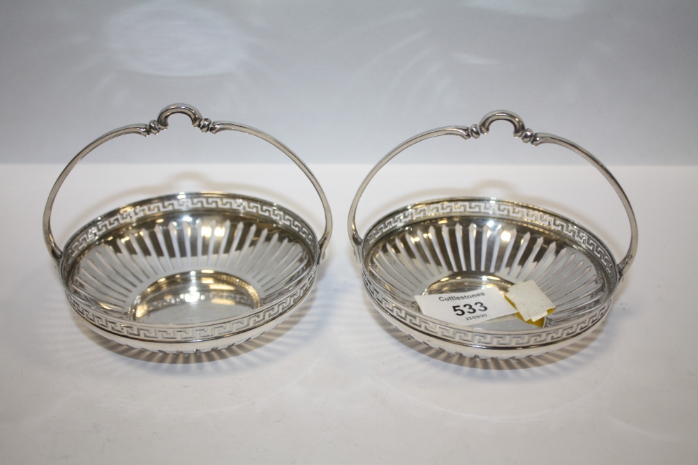 A PAIR OF WMF CIRCULAR SILVER PLATED BASKETS, with openwork and Greek key design border, basket