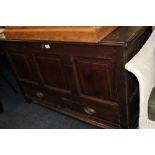 AN ANTIQUE OAK PANELLED MULE CHEST, the original hinged lid above a triple panel front and two