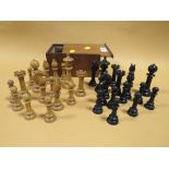 A BOX OF VINTAGE CARVED WOODEN CHESS PIECES IN BOX MARKED CHASSEREAU'S WAREHOUSE