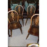 A SET OF FOUR OAK WHEELBACK CHAIRS