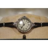 A LADIES VINTAGE PLATINUM AND DIAMOND SET WATCH - EACH BRILLIANT CUT DIAMOND APPROX 0.02 CARATS -