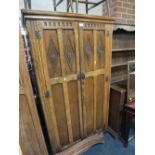 A CARVED OLD CHARM OAK WARDROBE