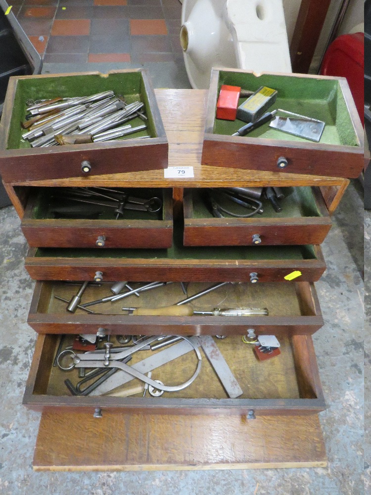 A VINTAGE OAK TABLETOP TOOL CABINET AND CONTENTS